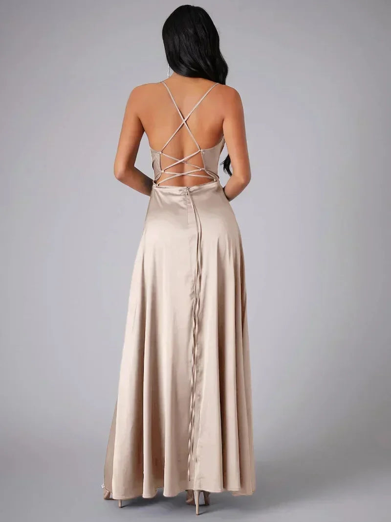 Formal women's long evening gown, featuring a stylish high slit, open back, & draped neckline for parties.