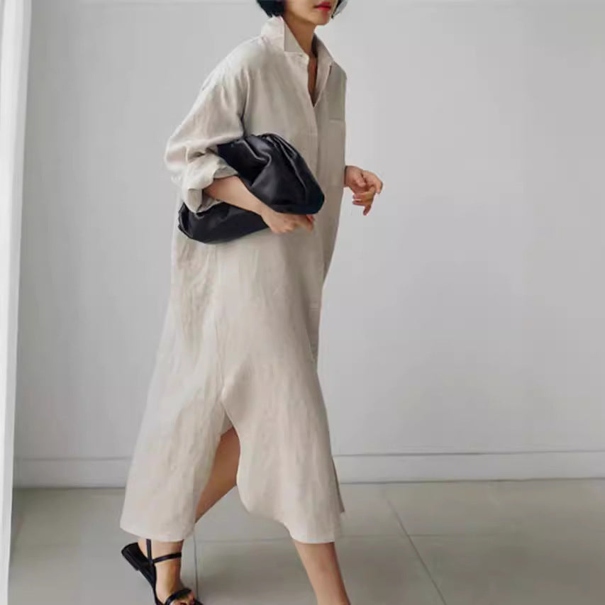 Close-up of a women's versatile midi shirt dress, showing roll sleeves & full button-down design.