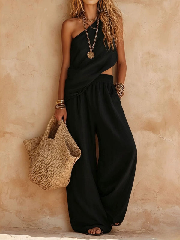 Fashionable women's one-shoulder draped jumpsuit with a wide leg, perfect for a chic vacation look.