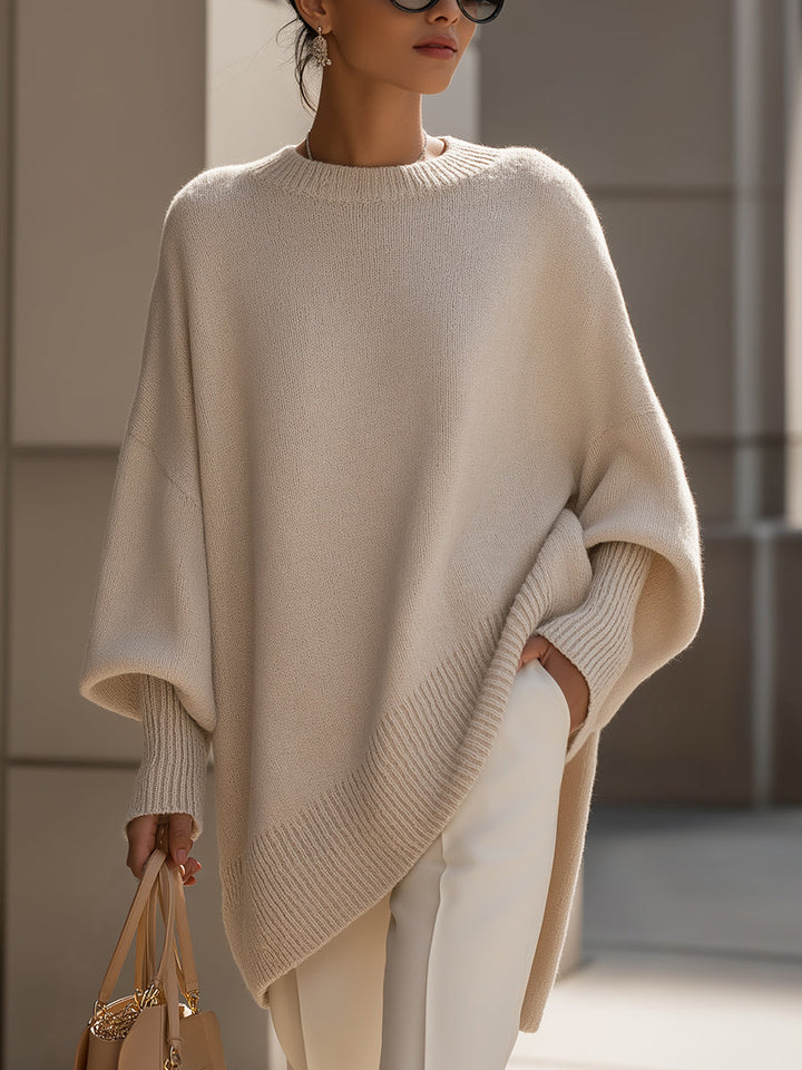 Women's elegant oversized cape sweater poncho in soft knit, perfect for chic fall layering.