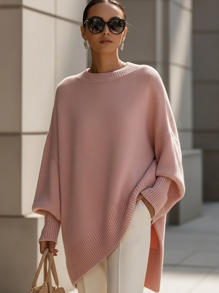 Back view of women's elegant oversized cape sweater poncho, featuring flowing, comfortable silhouette for fall.