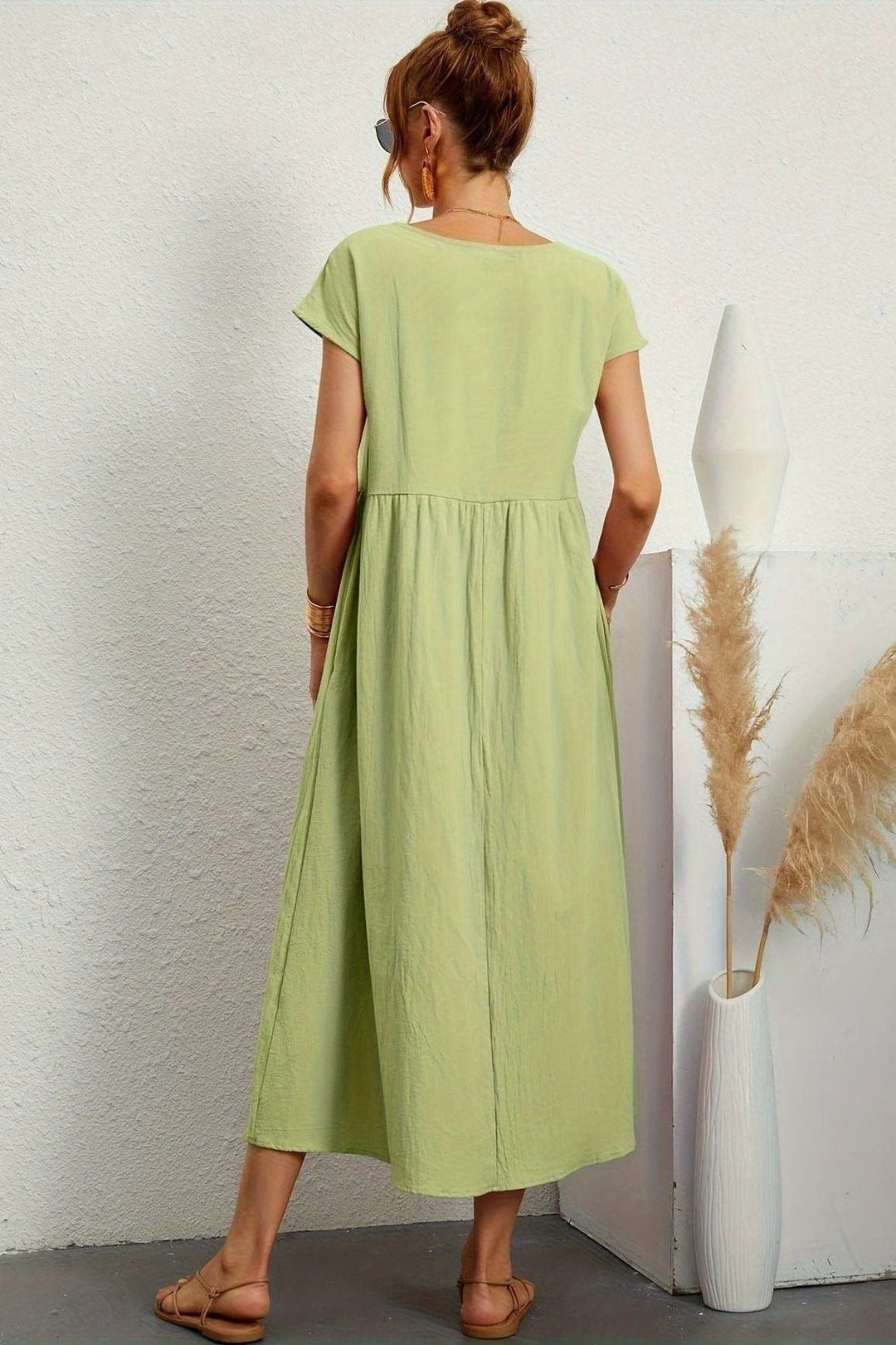 Women's modest pleated midi dress, offering an elegant look & comfortable fit. Spring/summer chic.