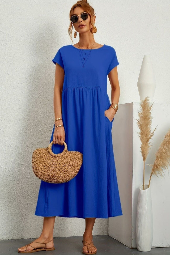 Modest & elegant women's pleated midi dress. Ideal for spring fashion, offering effortless style.