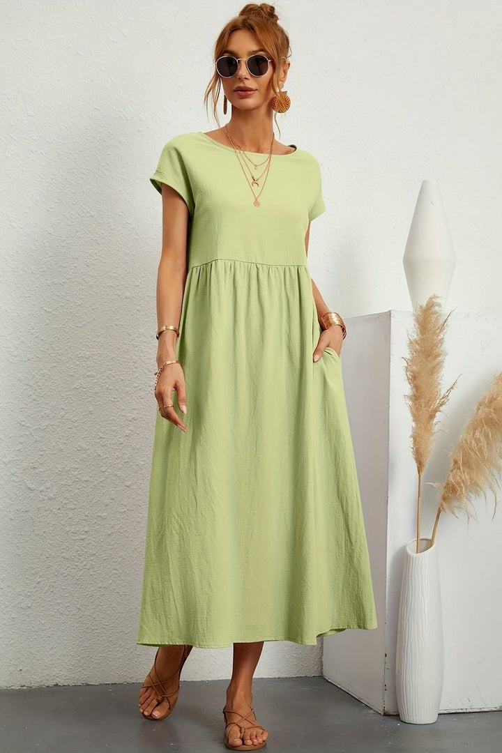 Women's elegant pleated midi dress, designed for effortless style & comfort. Spring/summer essential.