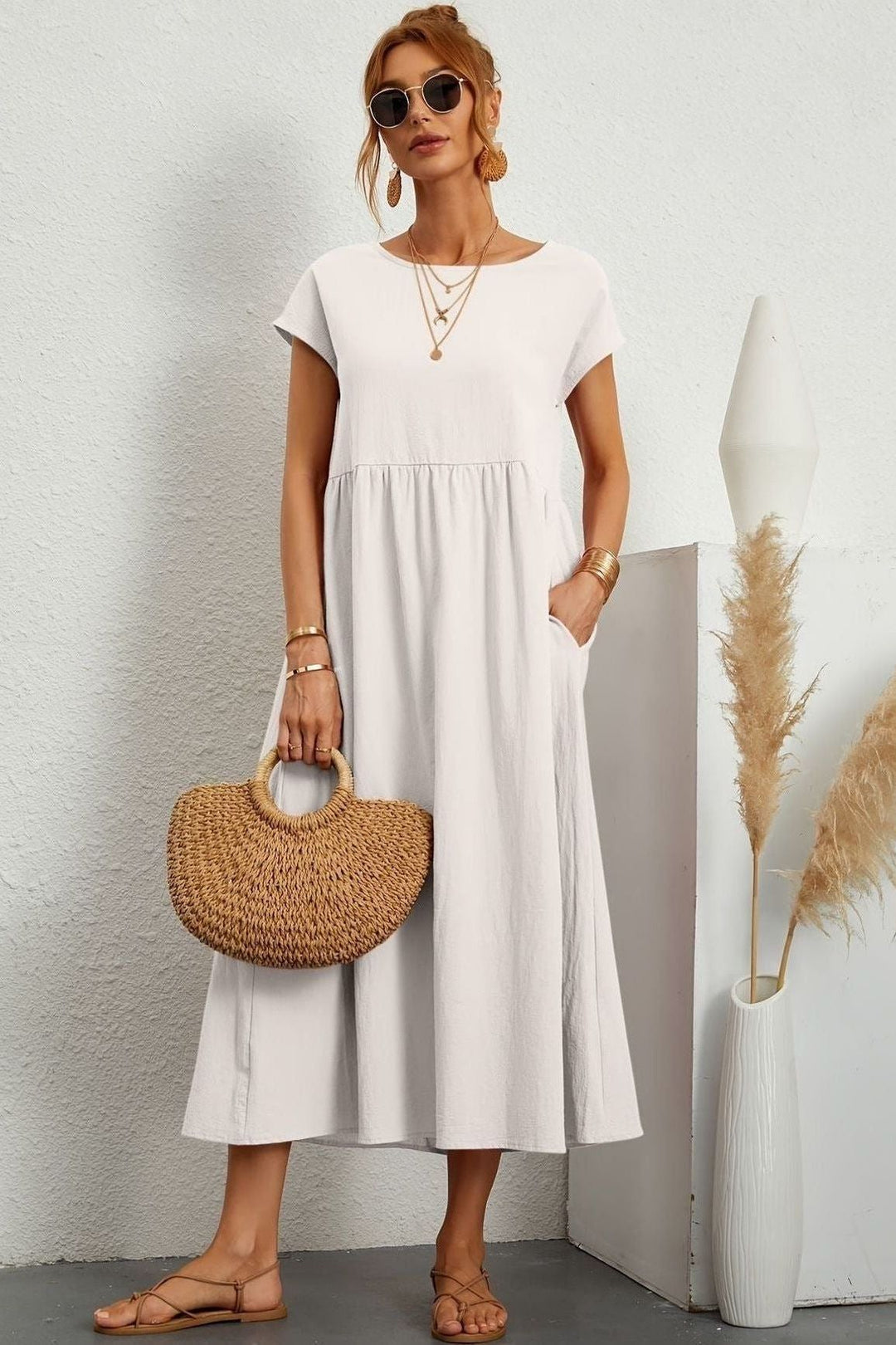 Women's modest pleated midi dress, offering an elegant look and comfortable fit. Spring/summer ready.