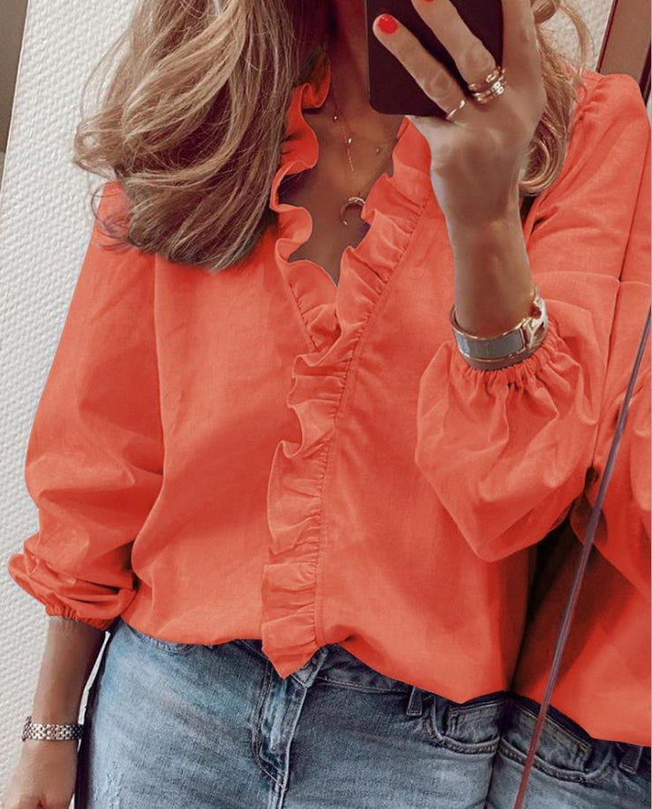 Elegant ruffled V-neck women's top, a fashionable long sleeve blouse for modern style.