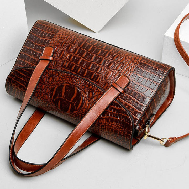Black women's embossed shoulder bag with luxurious crocodile texture, a versatile and elegant fashion accessory.