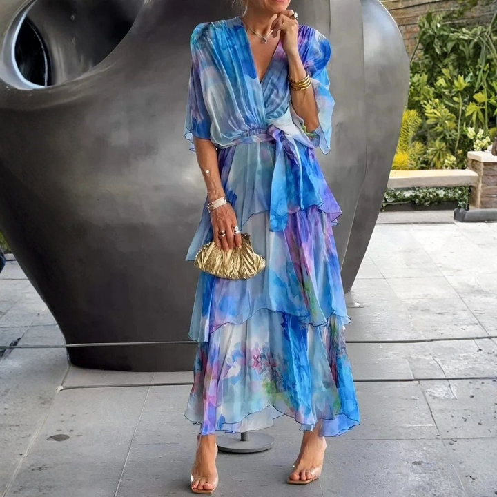 Long formal tiered wrap dress for women, ideal as a wedding guest gown or for a party.
