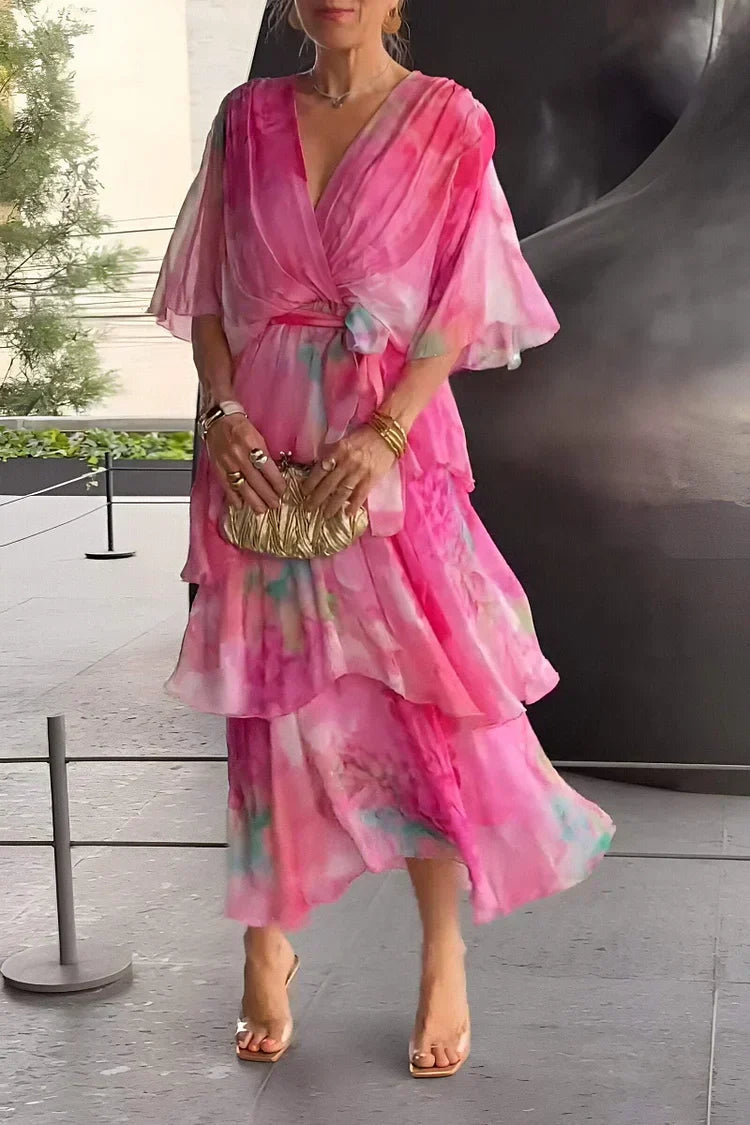 Women's long tiered wrap dress with a vibrant print, suitable for sophisticated evening wear.