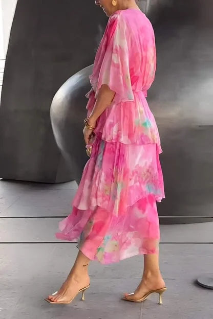 Chic women's wrap dress with tiered skirt and elegant print, perfect for a formal event or gala.