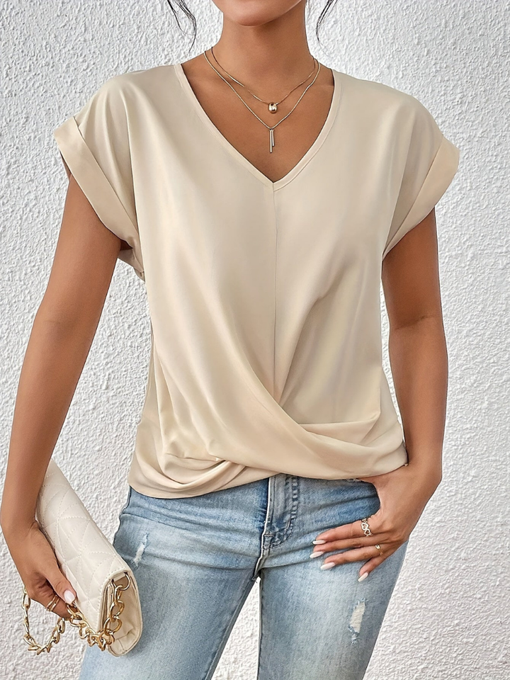 Women's fashion V-neck top with a unique twist front. Short sleeve for casual or dressed-up occasions.
