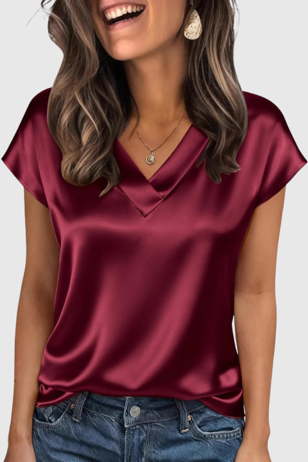 Chic short-sleeve V-neck blouse for women. Elegant top, great for summer, casual wear, or professional work outfits.
