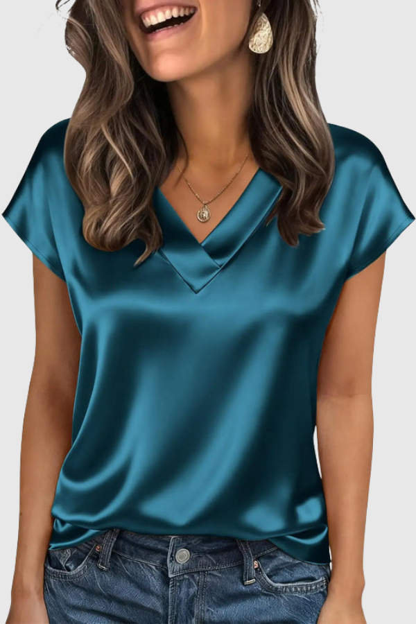 Comfortable women's V-neck summer blouse. Elegant short-sleeve top with a relaxed fit for versatile everyday style.