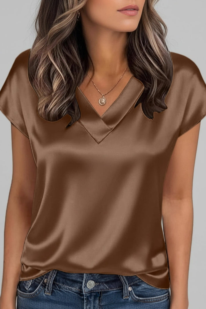 Lightweight women's elegant V-neck blouse. Flowy short-sleeve summer top, ideal for casual chic or office wear.