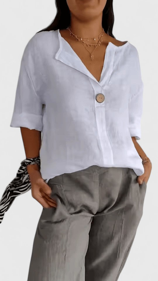 Comfortable women's V-neck knot blouse. A loose-fit top for elegant casual summer wear.