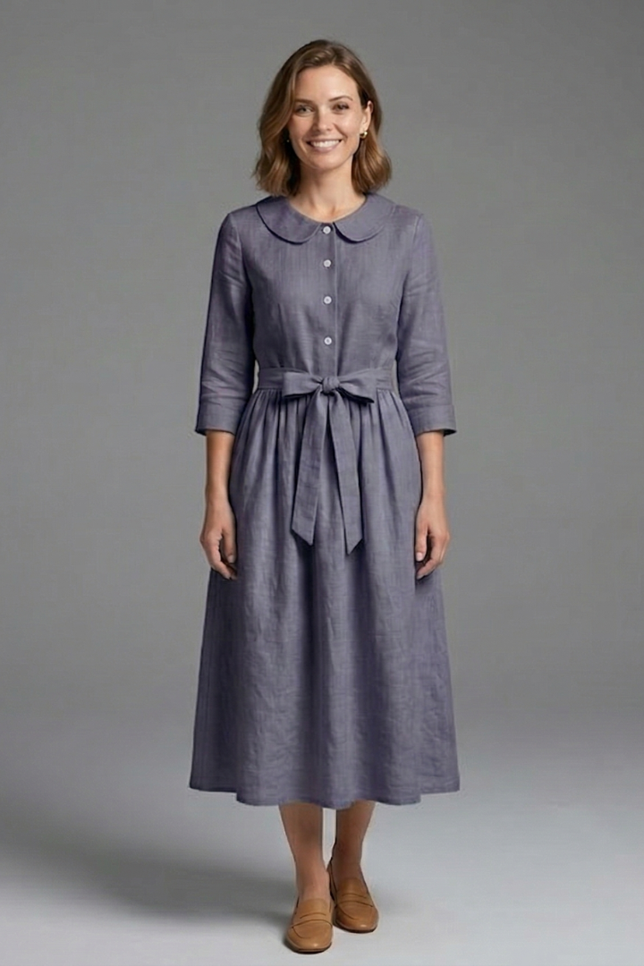 Hemline detail of a versatile women's midi dress. V-neck and waist tie for a chic, flattering look.