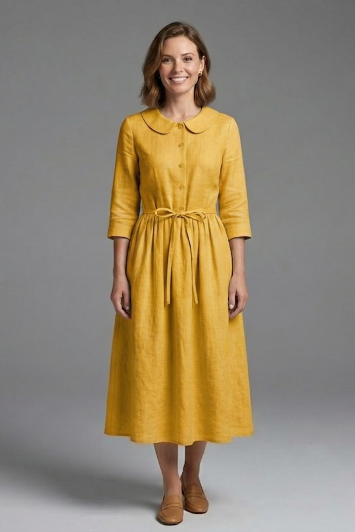Women's elegant V-neck midi dress with waist tie, styled with accessories. Summer fashion essential.