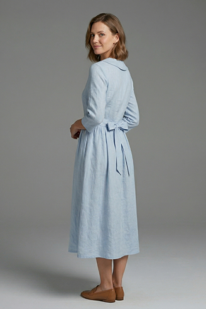 Adjustable waist tie detail on a chic women's V-neck midi dress. Enhances the silhouette and style.