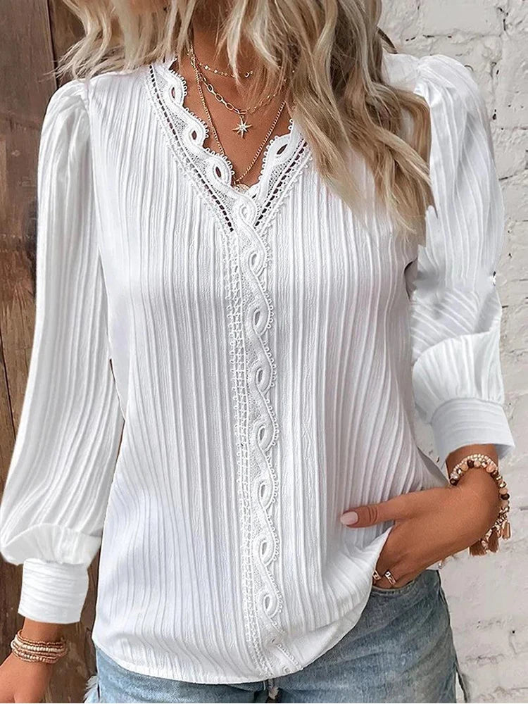Women's elegant white lace top with delicate lace detailing and fashionable puff sleeves.