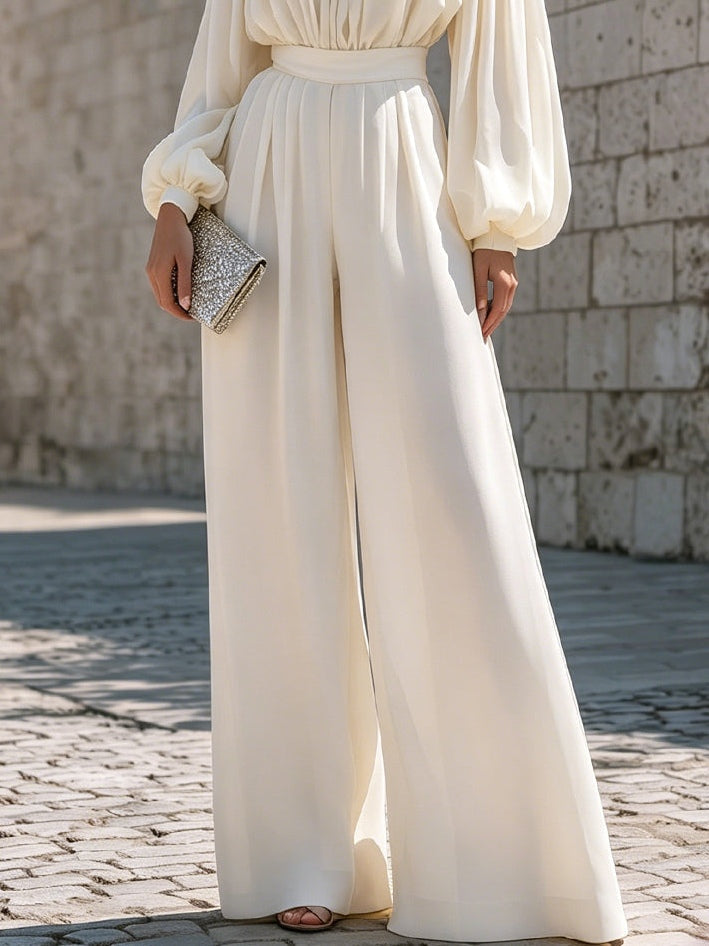Front view of an elegant white off-shoulder maxi dress, showing bishop sleeves and flowing silhouette.