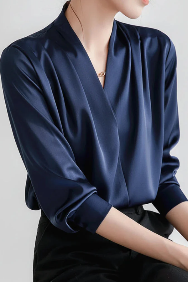 Refined women's long sleeve wrap blouse. A versatile top for professional workwear or elegant casual outfits.