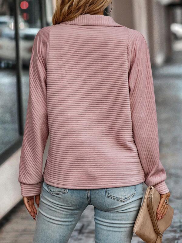 Women's elegant V-neck sweater, a comfortable knit with a stylish zipper detail.