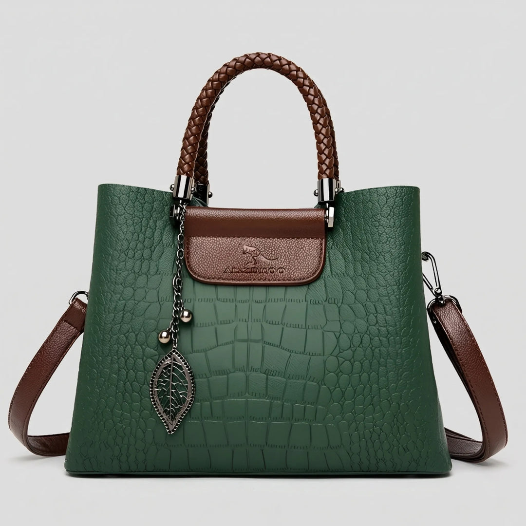 Stylish women's embossed faux leather tote bag. Features a unique braided handle, a perfect fashion accessory handbag.