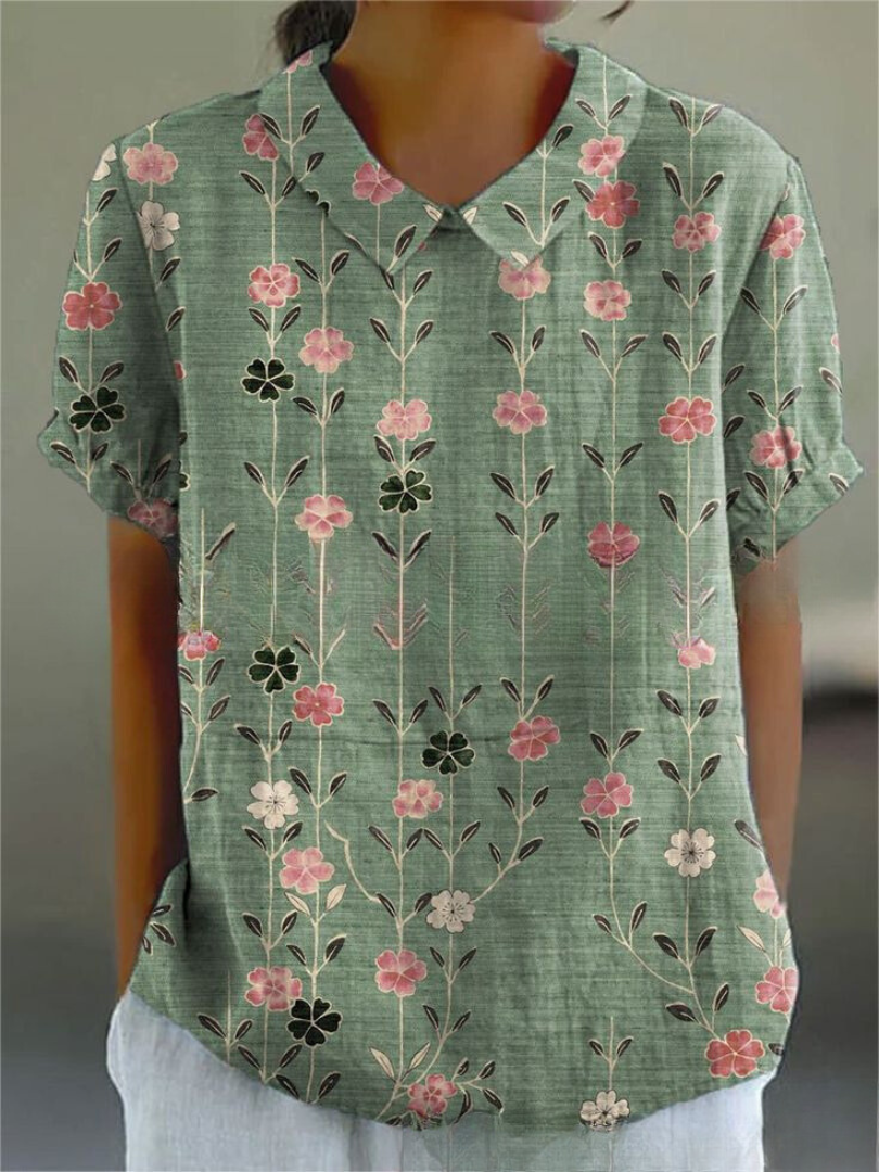 Full view of a women's vintage style floral embroidered blouse with a crisp Peter Pan collar.