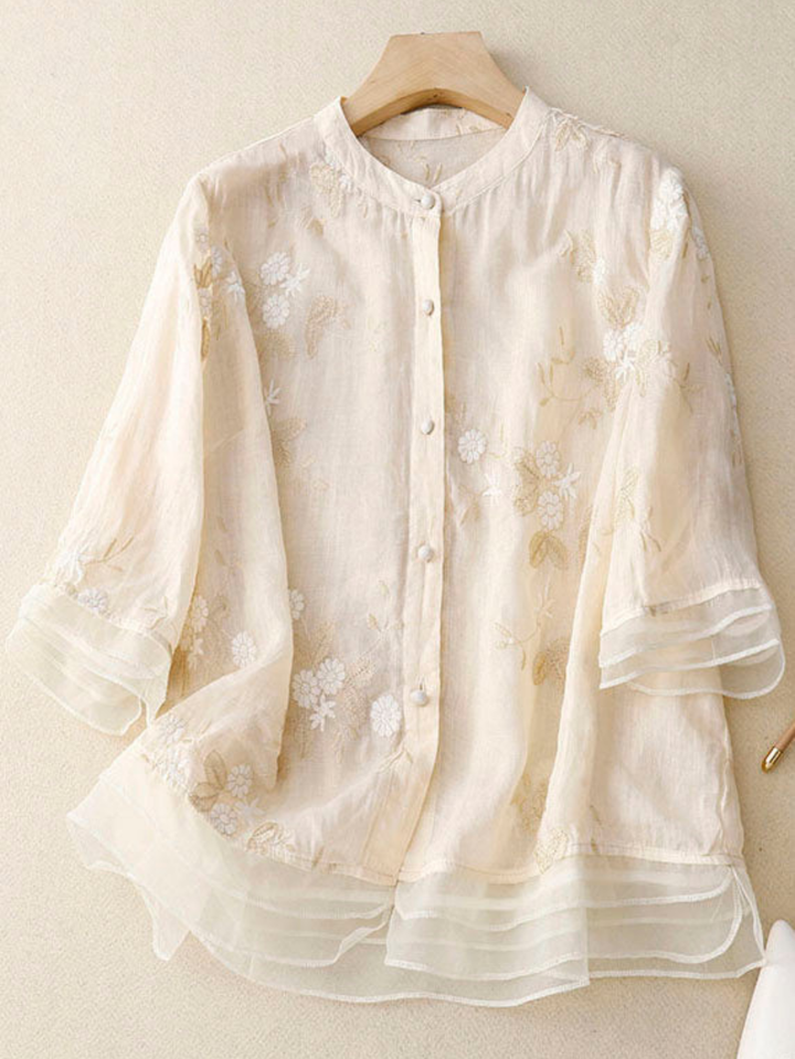 Women's embroidered long-sleeve blouse with button front, loose fit, elegant design.