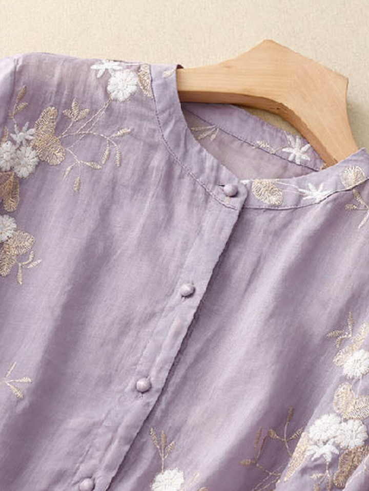 Women's button-front blouse, elegant embroidered details, long sleeves, loose fit, versatile spring wear.