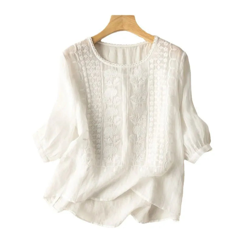 Women's embroidered puff sleeve blouse with floral design, round neck, and three-quarter sleeves.