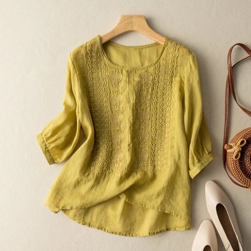 Casual chic women's loose fit blouse, featuring puff sleeves, floral embroidery, and a round neck.