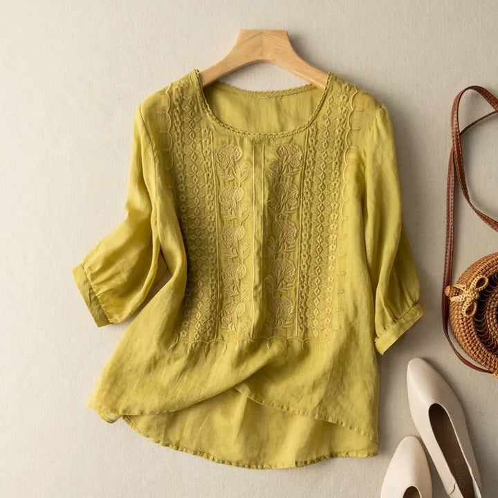 Casual chic women's loose fit blouse, featuring puff sleeves, floral embroidery, and a round neck.