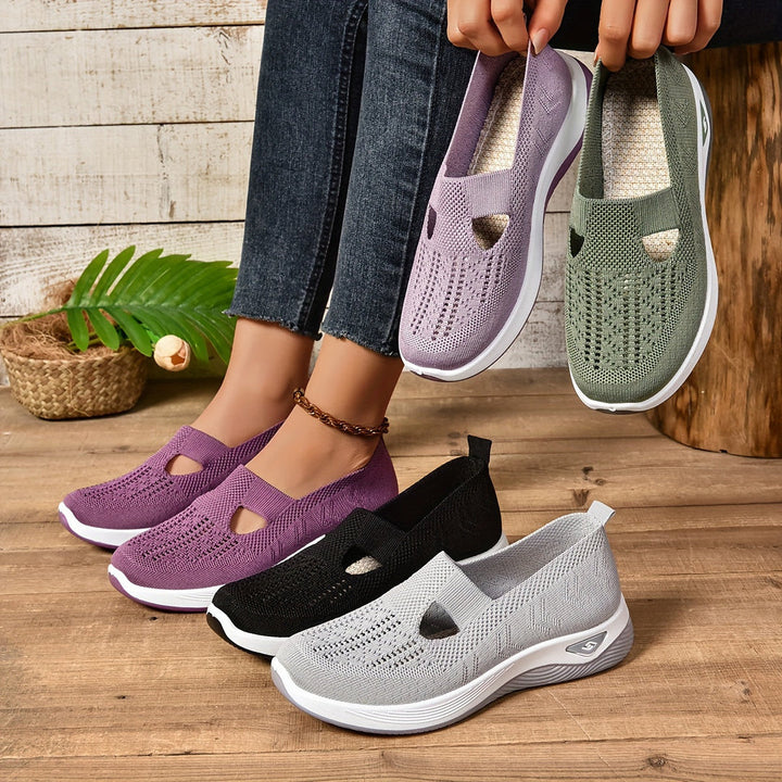 Women's ergonomic slip-on sneakers in black, offering all-day comfort for daily wear and walking.