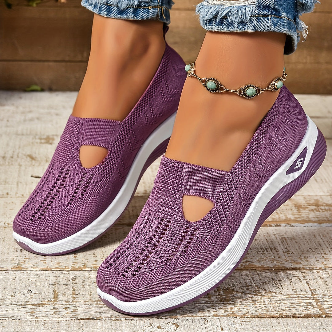 Comfortable black slip-on sneakers for women, ergonomic design makes them ideal walking shoes.