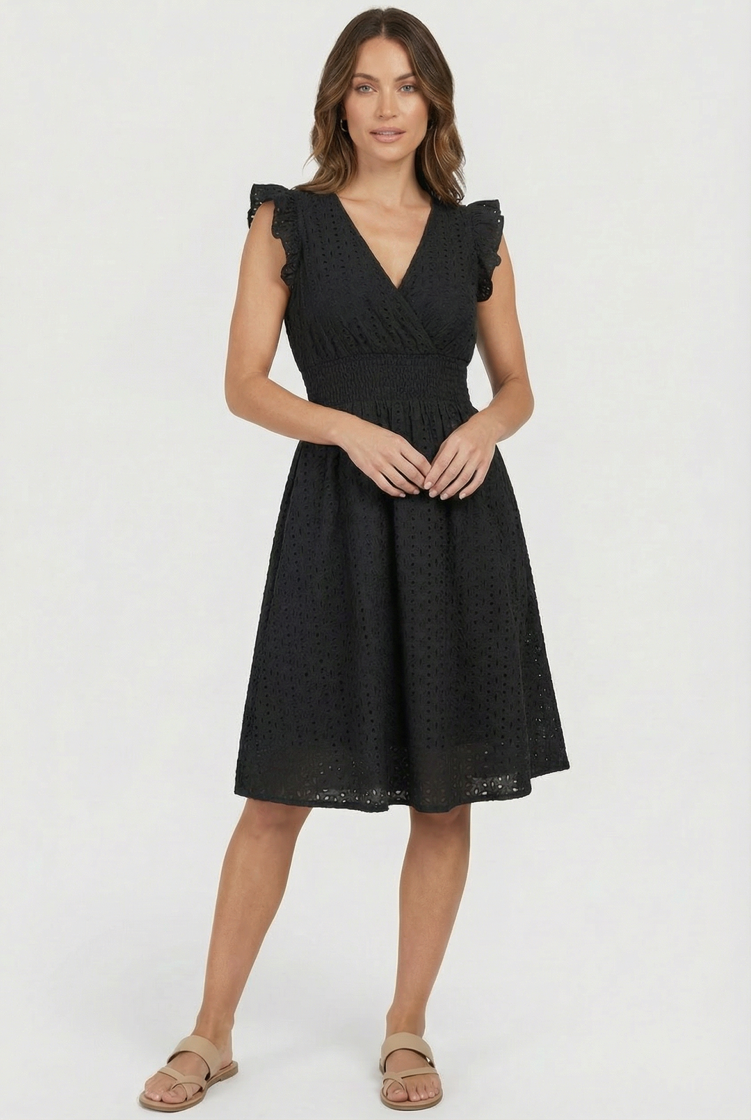 Breezy women's flared eyelet midi dress with ruffled cap sleeves, perfect beach or casual summer outfit.