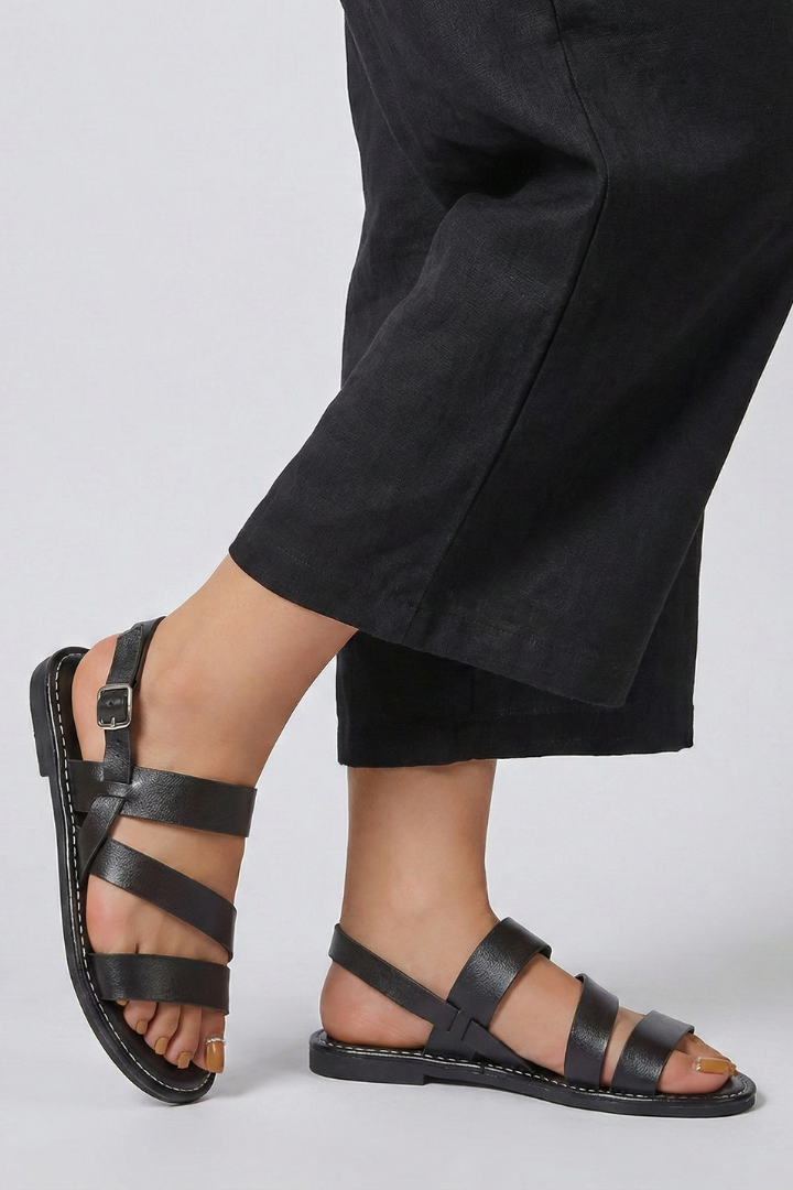 Stylish open-toe flat sandals for women, featuring a secure back strap for comfortable all-day wear.