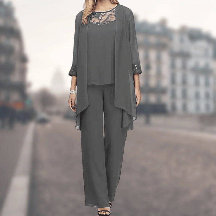 Comfortable women's three-piece lounge set with flowy wide-leg pants, jacket, and delicate lace trim details.
