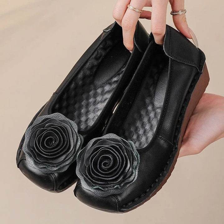 Comfortable women's slip-on loafers with intricate floral appliqué detail.