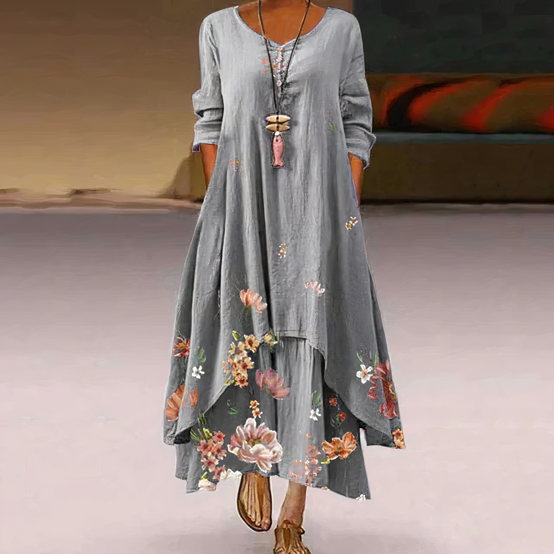 Flowing women's maxi dress featuring a beautiful floral border print and comfortable long sleeves.