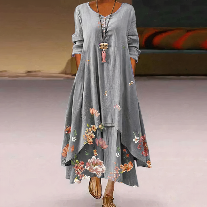 Flowing women's maxi dress featuring a beautiful floral border print and comfortable long sleeves.