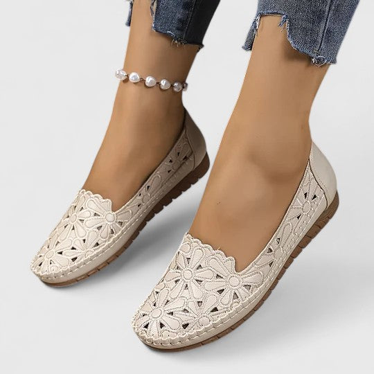 Womens casual ballet flats with decorative floral cutouts, comfortable slip-on for everyday use.