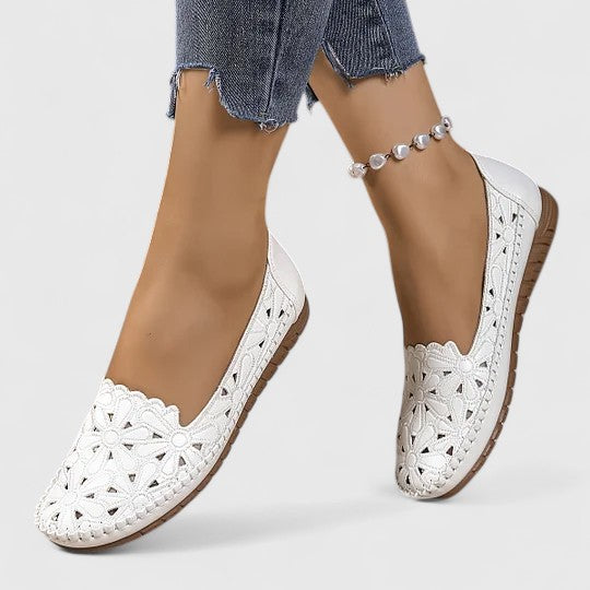 Beige women's floral cutout ballet flats, comfortable everyday slip-on shoes with scalloped trim.