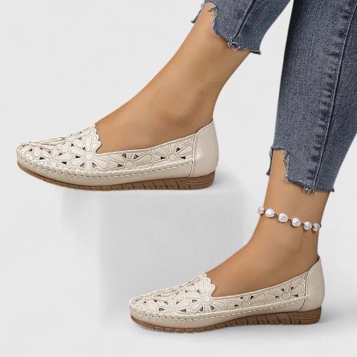Comfortable women's floral cutout ballet flats with perforated design, ideal for daily wear.