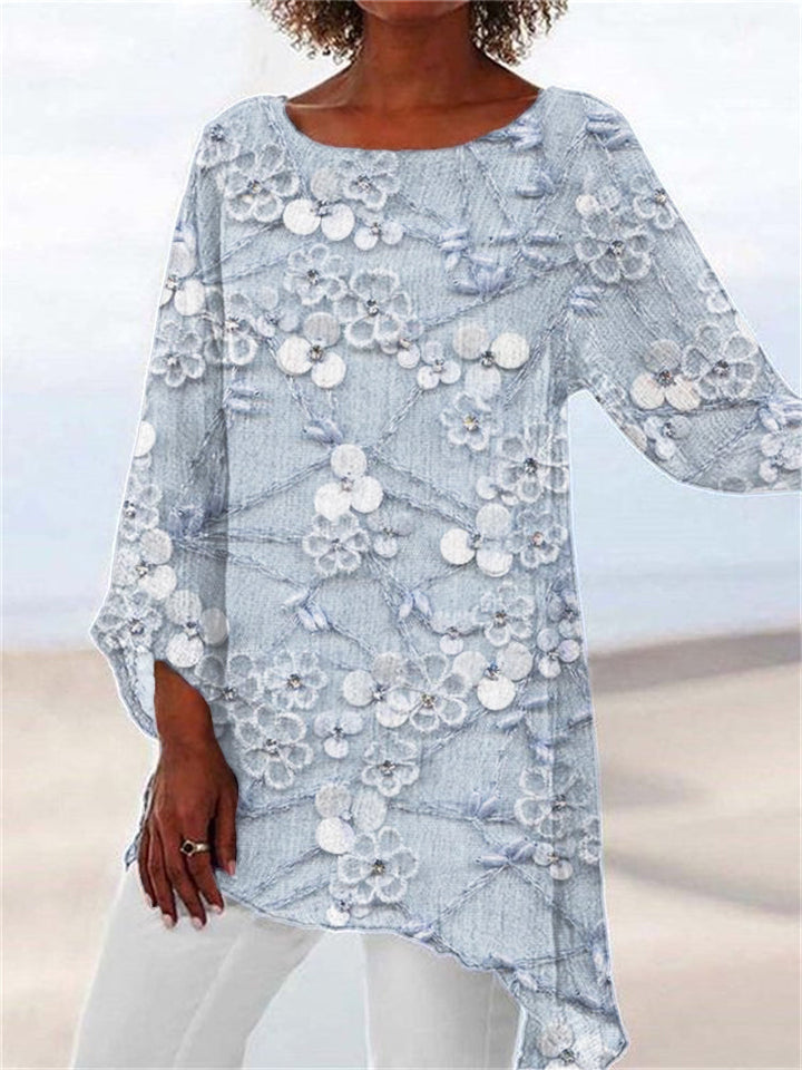 Feminine long sleeve tunic for women, featuring intricate floral embroidery & a stylish asymmetrical hem. Everyday chic.