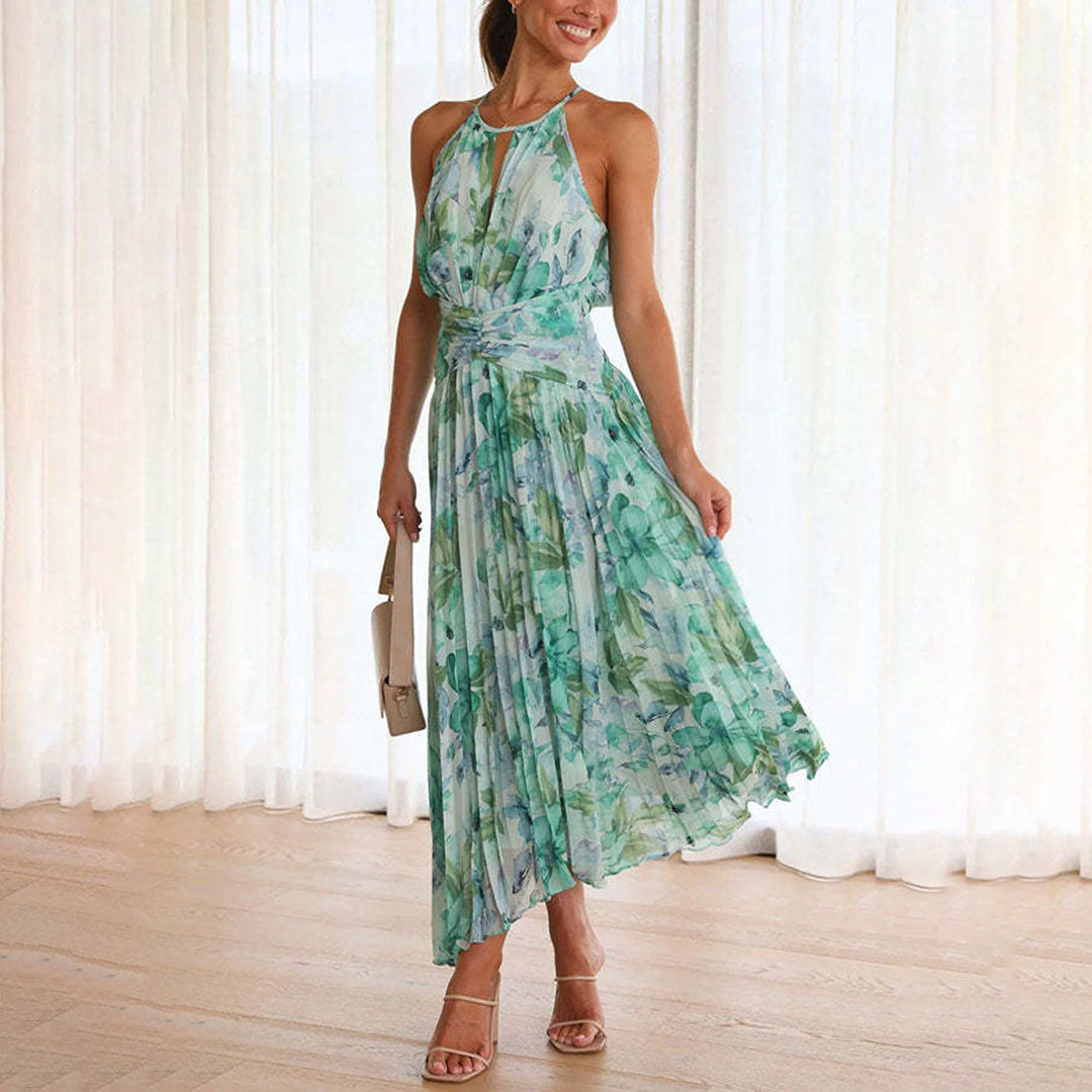 Women's floral halter neck maxi dress with elegant pleats, perfect for summer occasions.