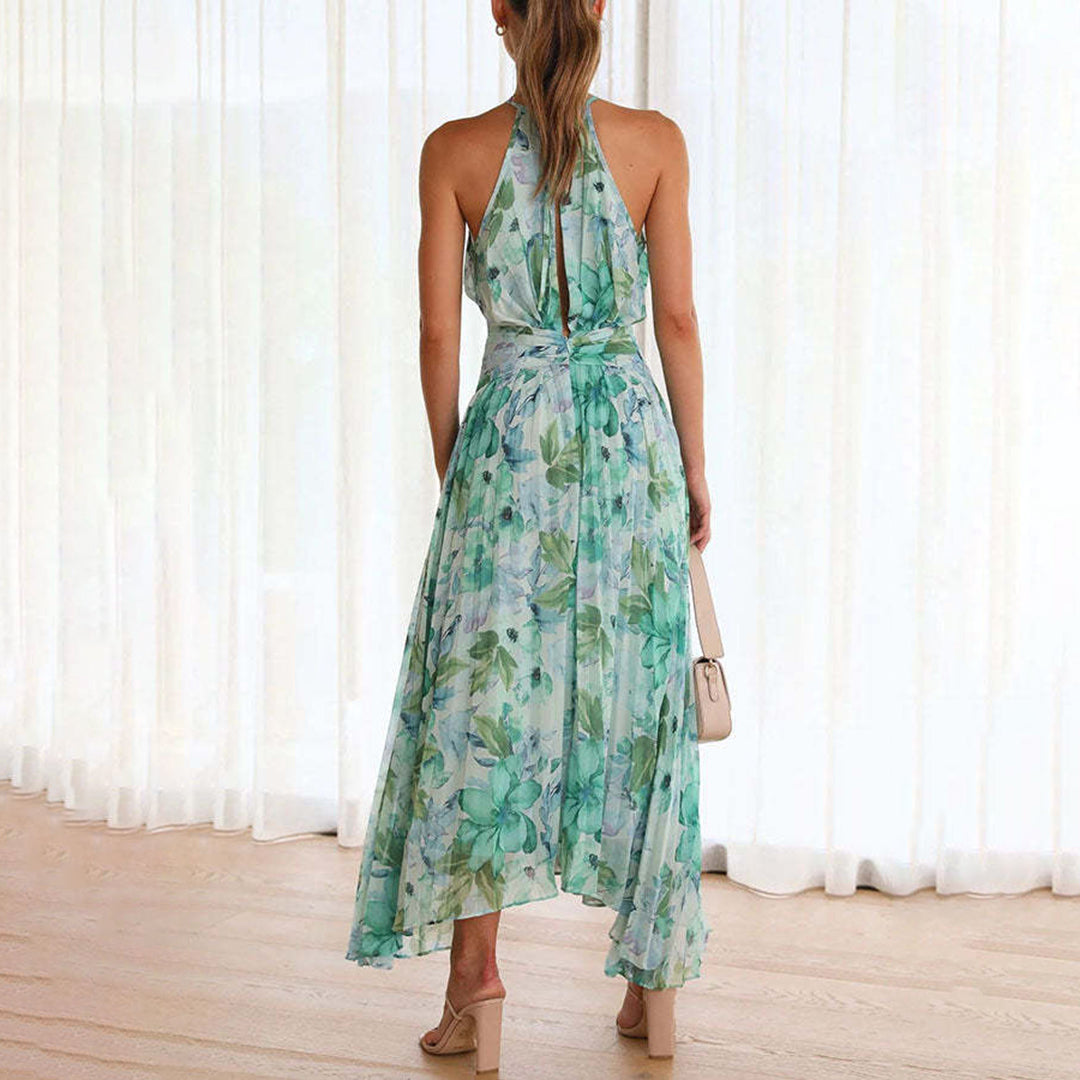 Flowy pleated maxi dress for women, featuring a beautiful floral print and chic halter neckline.