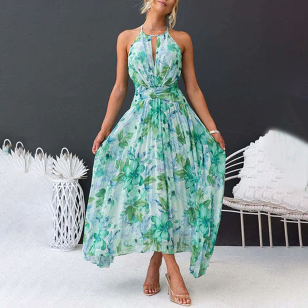 Stylish women's summer maxi dress with a vibrant floral print, halter neck, and elegant pleats.