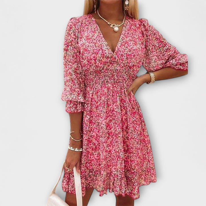 Women's floral midi dress with puff sleeves & A-line silhouette, perfect for summer garden parties.
