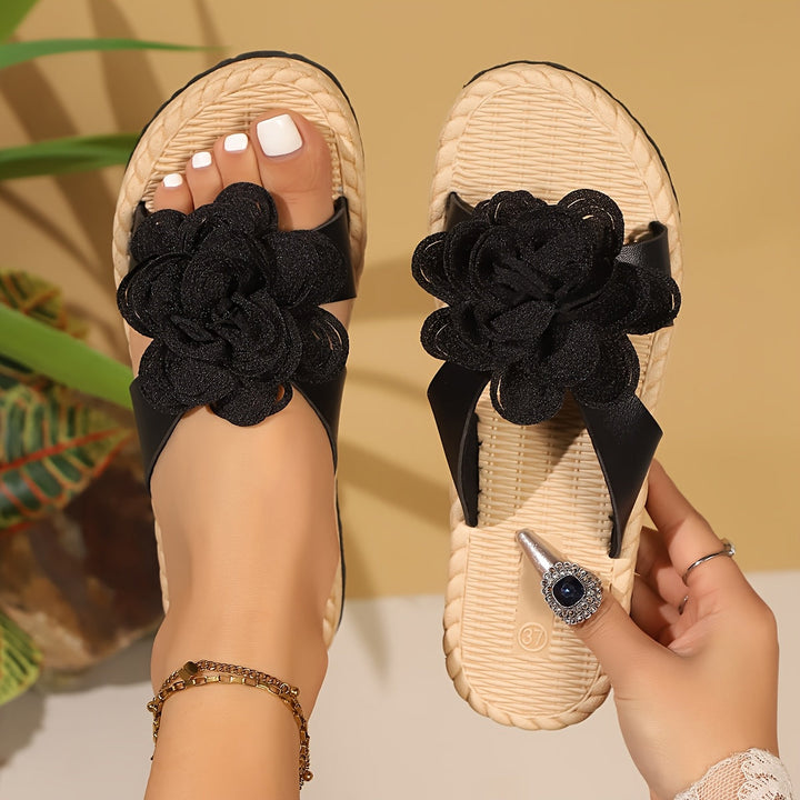 Open-toe women's sandals featuring a vibrant floral pattern. Comfortable footwear for everyday summer style.